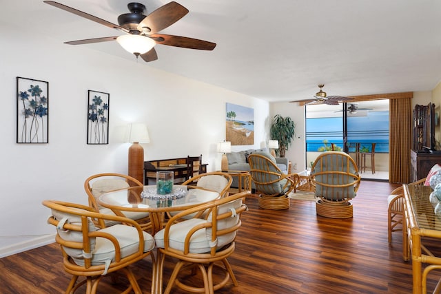 dining space with ceiling fan and dark hardwood / wood-style flooring