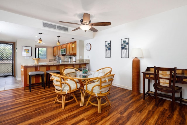 dining room with dark hardwood / wood-style floors and ceiling fan