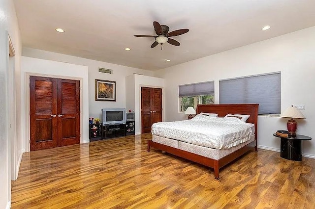 bedroom featuring recessed lighting, wood finished floors, a ceiling fan, baseboards, and visible vents