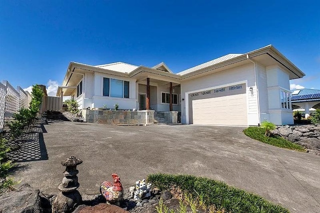 ranch-style house featuring driveway, an attached garage, and fence