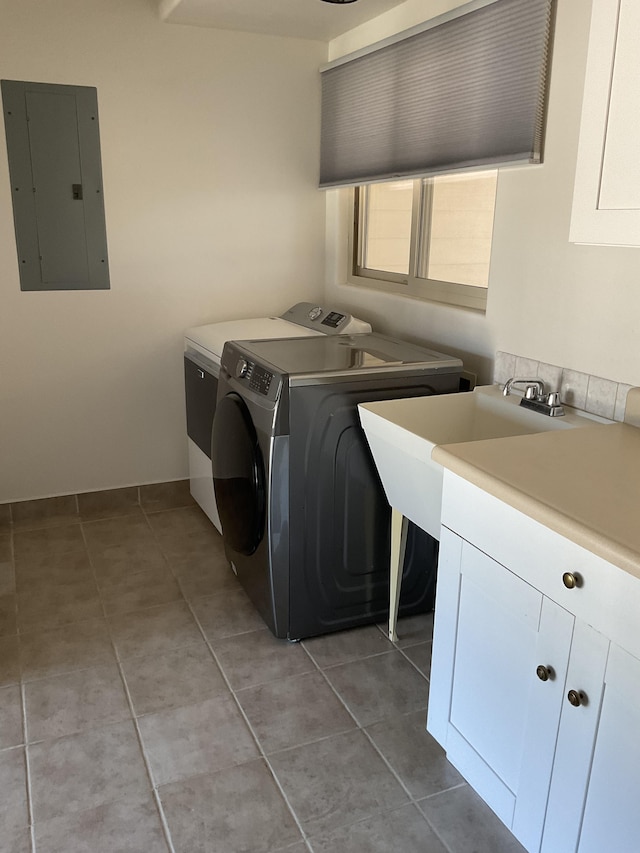 clothes washing area featuring cabinet space, electric panel, light tile patterned floors, and independent washer and dryer