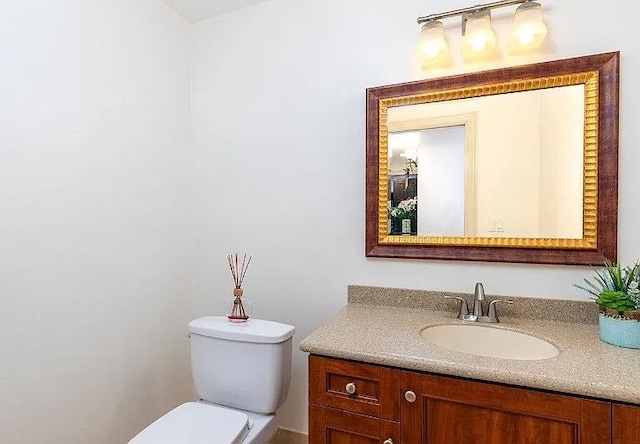 bathroom featuring toilet and vanity