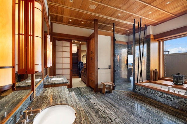 bathroom featuring vanity, wood-type flooring, a bathtub, and wood ceiling