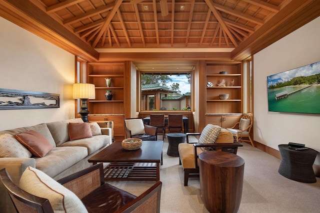 carpeted living room with vaulted ceiling with beams, built in shelves, and wooden ceiling