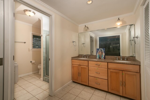 bathroom with crown molding, tile patterned floors, and vanity