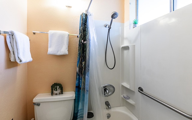 bathroom with shower / bath combination with curtain and toilet