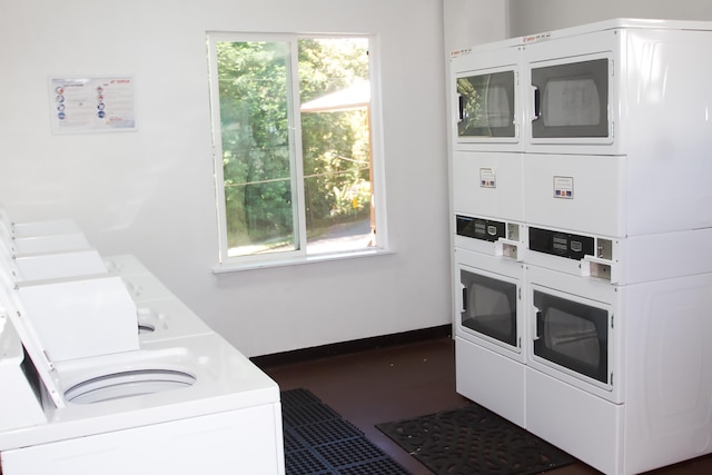 clothes washing area with stacked washer and clothes dryer and washing machine and clothes dryer