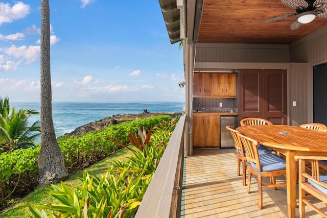 balcony with a water view, ceiling fan, and sink