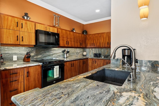 kitchen with light stone countertops, sink, backsplash, and black appliances