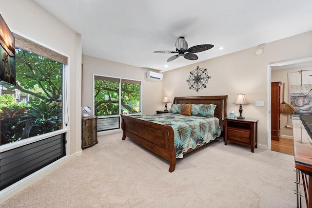 carpeted bedroom with ceiling fan and a wall unit AC