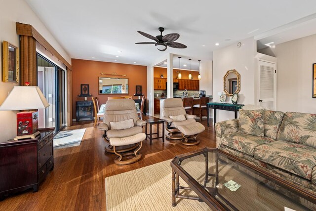 living room with hardwood / wood-style flooring and ceiling fan