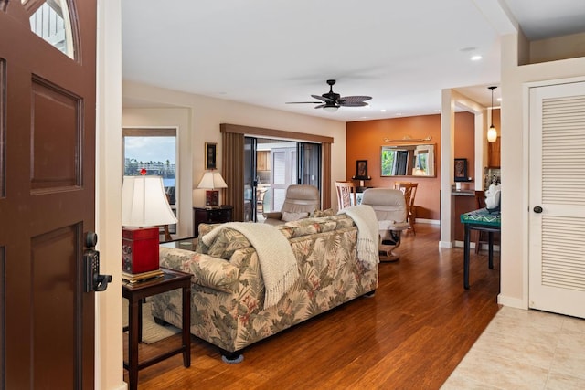 living room with ceiling fan, wood-type flooring, and a wealth of natural light