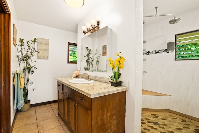 bathroom with tile patterned floors, vanity, and tiled shower