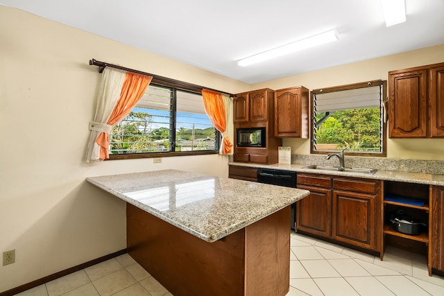 kitchen featuring black appliances, a healthy amount of sunlight, sink, and light stone counters