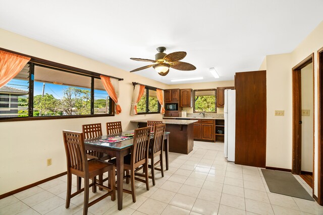 dining room with ceiling fan, sink, and light tile patterned floors