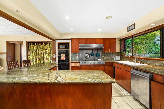 kitchen with black appliances, decorative backsplash, sink, and light tile patterned flooring