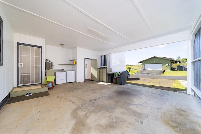 garage featuring washing machine and dryer and gas water heater