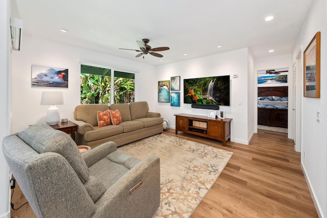 living room with ceiling fan and hardwood / wood-style floors