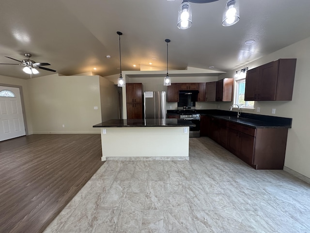 kitchen with ceiling fan, a center island, pendant lighting, sink, and stainless steel appliances