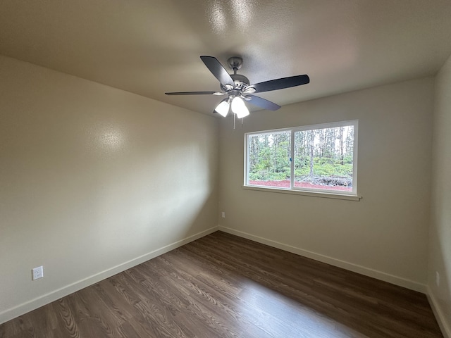 empty room featuring ceiling fan and dark hardwood / wood-style flooring