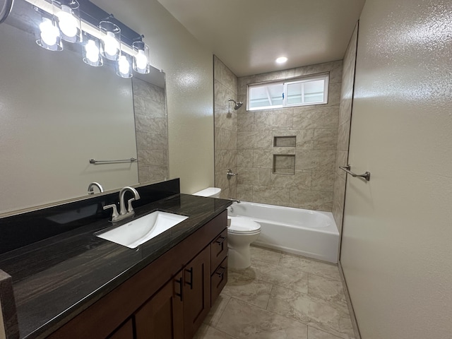 full bathroom featuring toilet, tiled shower / bath combo, and vanity