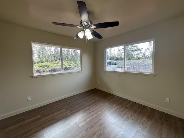 empty room featuring ceiling fan and dark wood-type flooring