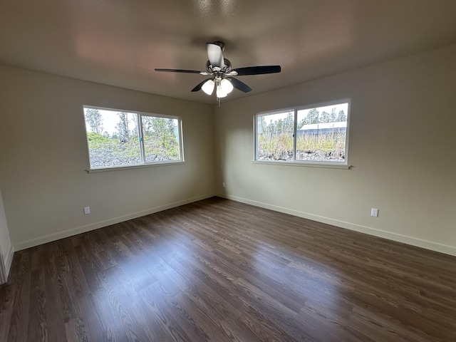 unfurnished room featuring ceiling fan and dark wood-type flooring