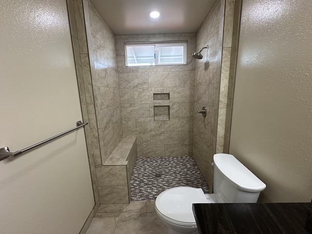 bathroom with toilet and tiled shower