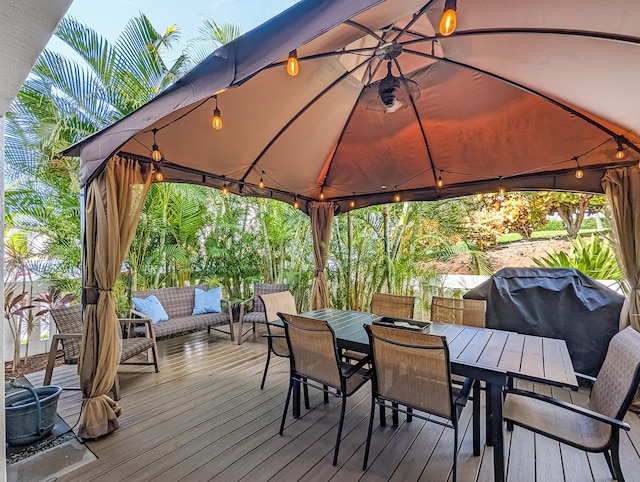 wooden terrace featuring outdoor lounge area, a gazebo, and area for grilling