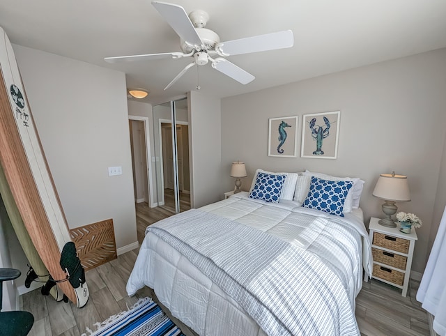 bedroom with ceiling fan, a closet, and light hardwood / wood-style floors