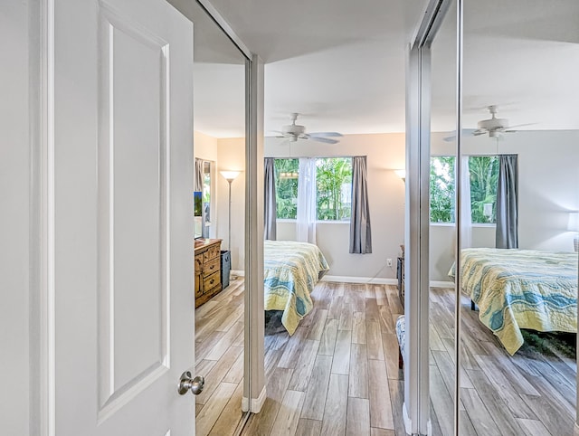 bedroom with ceiling fan and light wood-type flooring