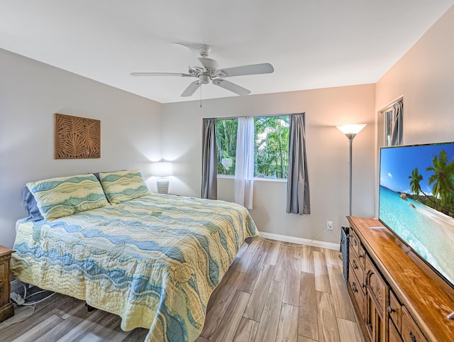 bedroom with light wood-type flooring and ceiling fan