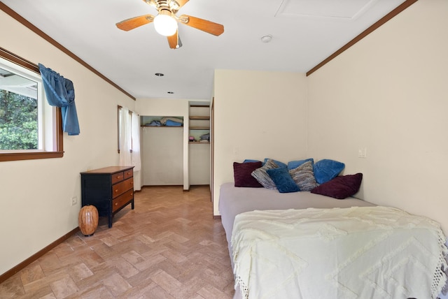 bedroom with ceiling fan, crown molding, and light parquet flooring