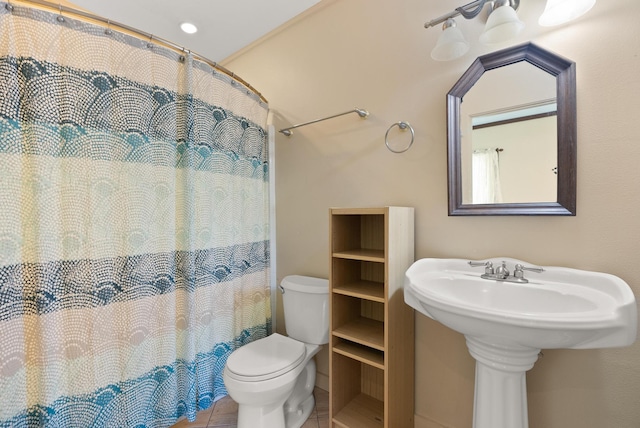 bathroom featuring tile patterned flooring, toilet, and a shower with shower curtain