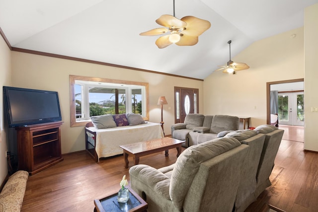 living room featuring dark wood-type flooring, vaulted ceiling, french doors, and a healthy amount of sunlight