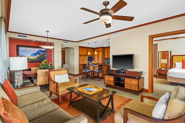 living area with baseboards, visible vents, and crown molding