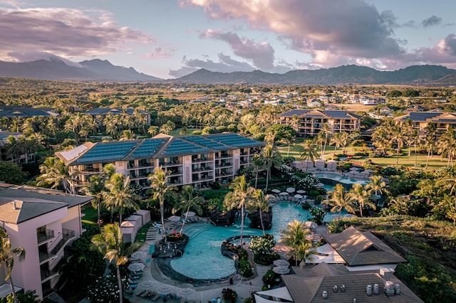 aerial view at dusk featuring a mountain view