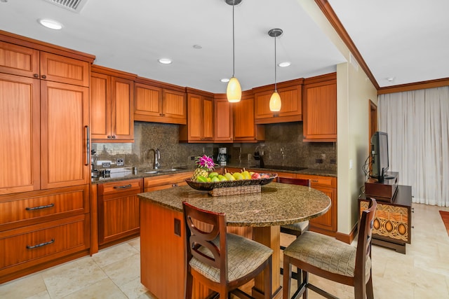 kitchen featuring black electric cooktop, a sink, a center island, decorative backsplash, and dark stone countertops