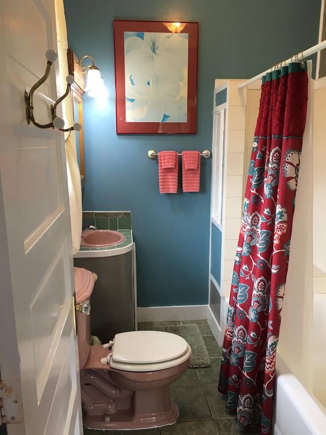 bathroom with tile patterned floors, toilet, and shower / bath combination with curtain