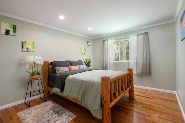 bedroom featuring crown molding and hardwood / wood-style floors