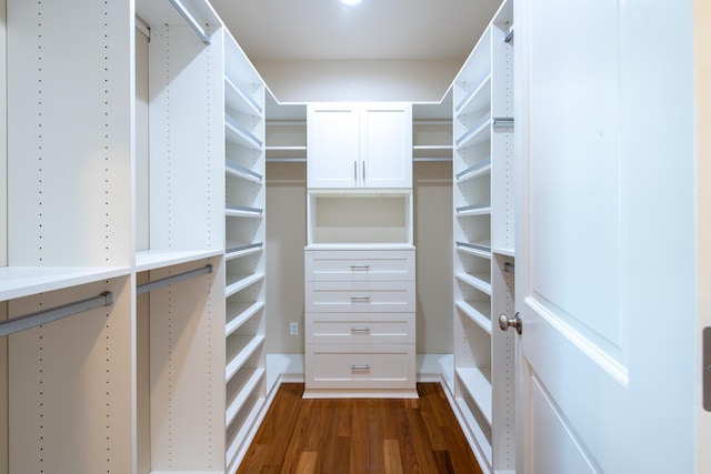 spacious closet with dark hardwood / wood-style floors