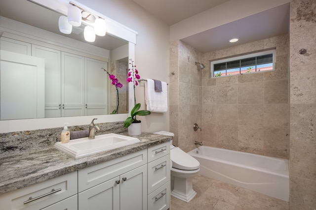 full bathroom featuring toilet, tiled shower / bath combo, and vanity