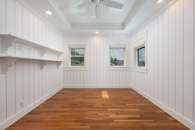 spare room featuring ceiling fan, a tray ceiling, dark hardwood / wood-style floors, and ornamental molding