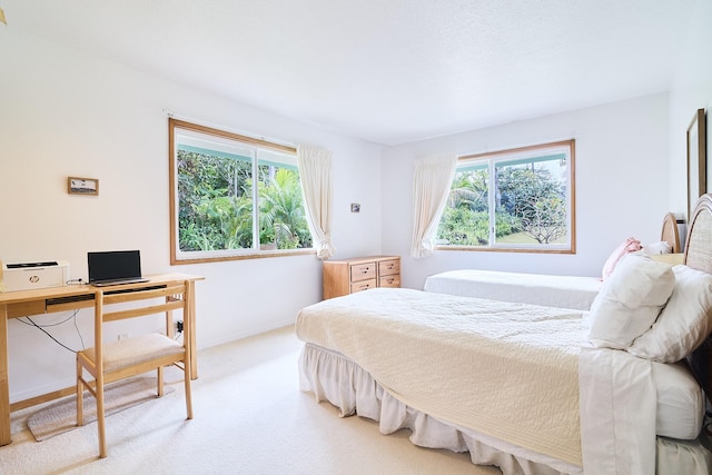 bedroom featuring light carpet