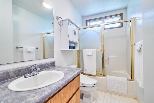 full bathroom featuring enclosed tub / shower combo, vanity, and toilet