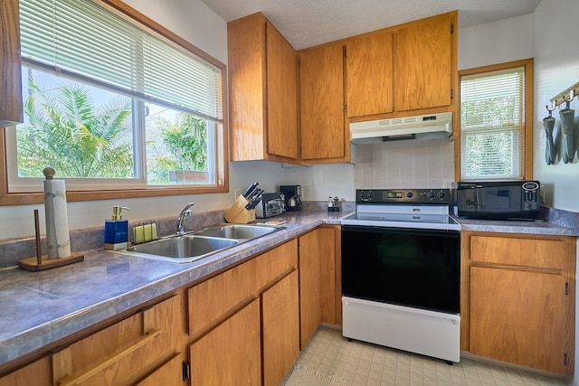 kitchen featuring sink, range with electric stovetop, and decorative backsplash