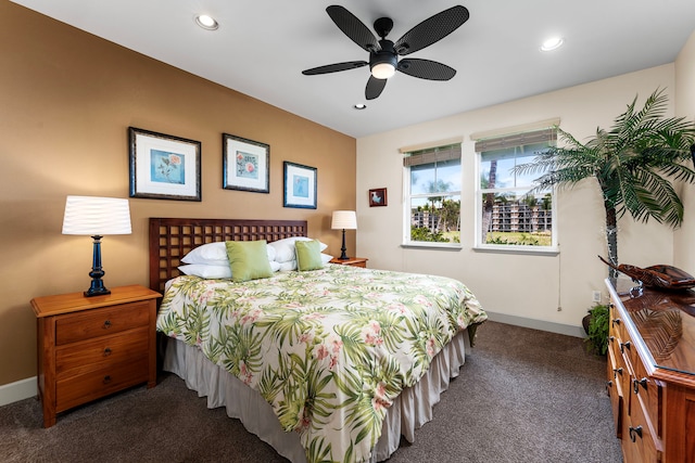 bedroom featuring ceiling fan and dark carpet