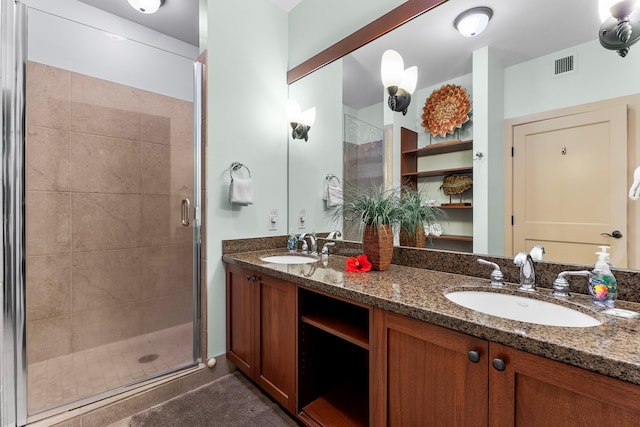 bathroom featuring vanity and a shower with door