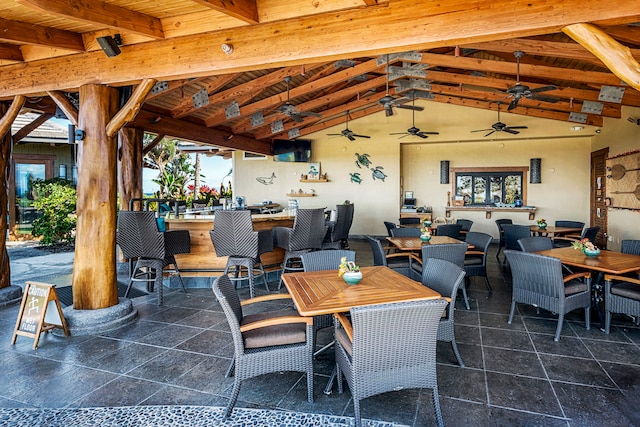 dining space featuring wooden ceiling, vaulted ceiling with beams, and ceiling fan