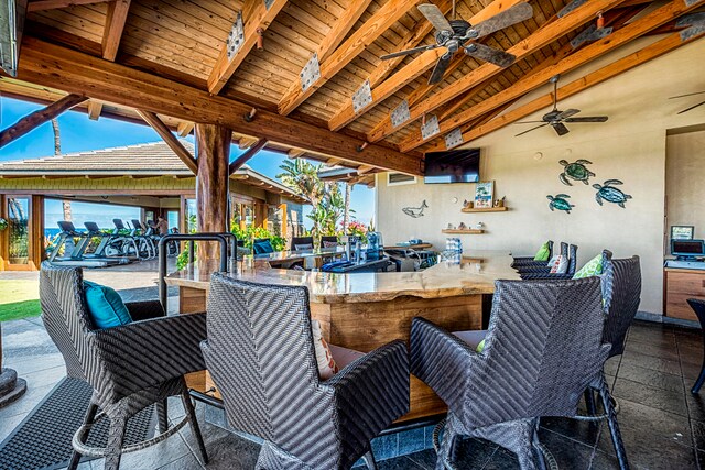 view of patio / terrace featuring ceiling fan and an outdoor bar